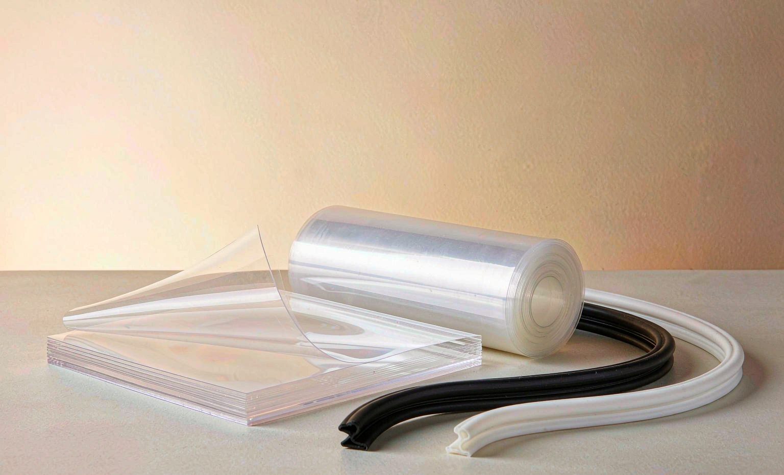 Clear PVC sheets, rolled film and rubber seal profiles on a light table